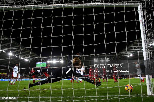 Alfie Mawson of Swansea City scores his side's first goal past Loris Karius of Liverpool during the Premier League match between Swansea City and...