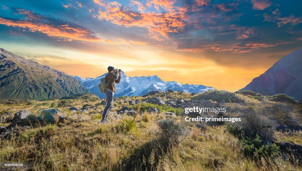Young traveler taking photo at mt cook famaus destination in new zealand