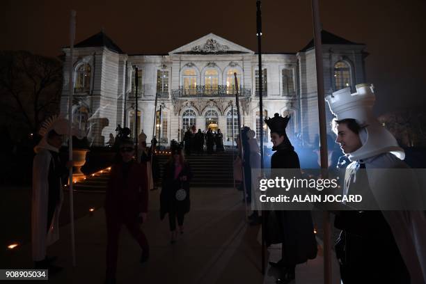 Hosts dressed as chequerboard pieces greet guests as they arrive for the Dior Ball at the Hotel Peyrenc de Moras in the grounds of the Rodin Museum...