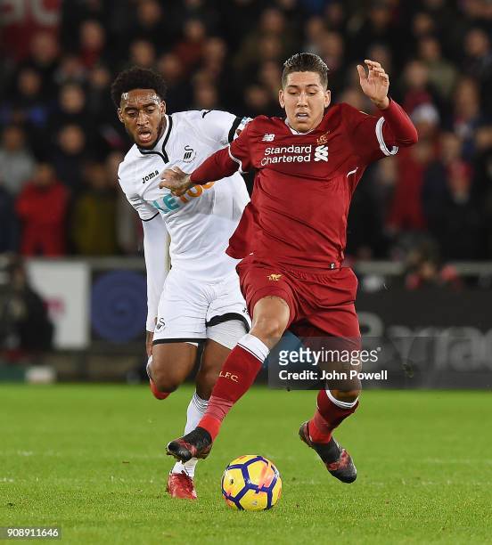 Roberto Firmino of Liverpool with Leroy Fer of Swansea during the Premier League match between Swansea City and Liverpool at Liberty Stadium on...