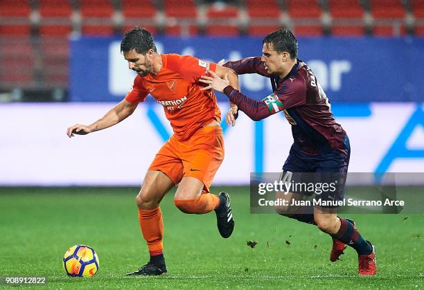 Daniel Garcia of SD Eibar duels for the ball with Adrian Gonzalez of Malaga CF during the La Liga match between SD Eibar and Malaga CF at Ipurua...