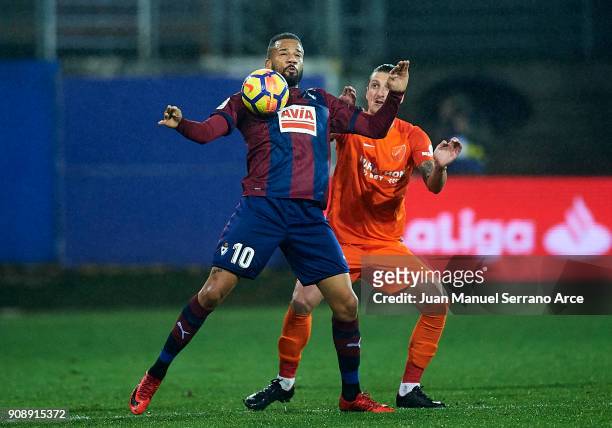 Tiago Manuel Dias Correia 'Bebe' of SD Eibar duels for the ball with Zdravko Kuzmanovic of Malaga CF during the La Liga match between SD Eibar and...
