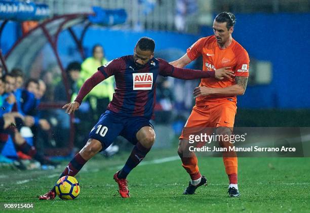 Tiago Manuel Dias Correia 'Bebe' of SD Eibar duels for the ball with Zdravko Kuzmanovic of Malaga CF during the La Liga match between SD Eibar and...