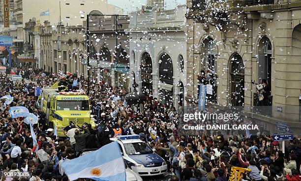 Confetti is thrown from the roof of a building as the newly-crowned US Open champion Juan Martin Del Potro passes on top of a fire engine on...