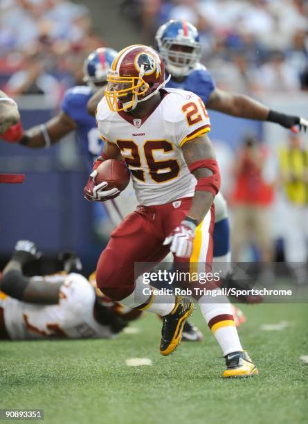 Clinton Portis of the Washington Redskins rushes against the New York Giants during their game on September 13, 2009 at Giants Stadium in East...