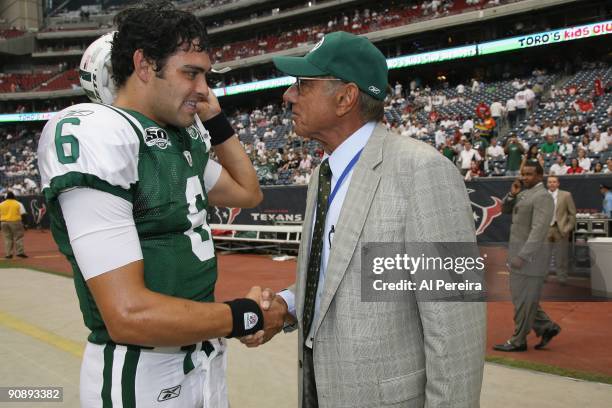 Quarterback Mark Sanchez of the New York Jets receives a pep talk from Hall of Fame Quarterback Joe Namath of the New York Jets before the game...