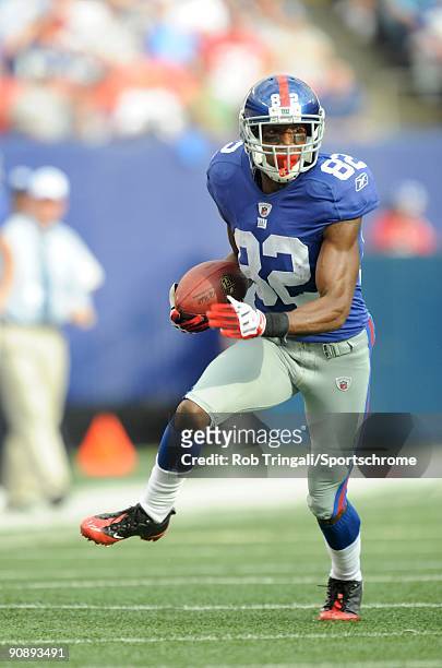Mario Manningham of the New York Giants runs with the ball against the Washington Redskins during their game on September 13, 2009 at Giants Stadium...