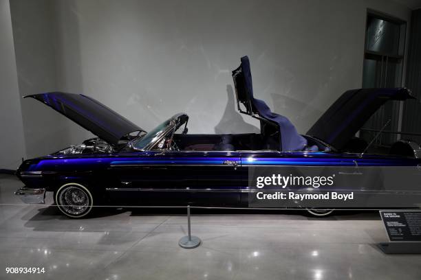 Chevrolet Impala Convertible 'Slippin' Into Darkness' is on display in the David and Ginny Sydorick Grand Concourse inside the Petersen Automotive...