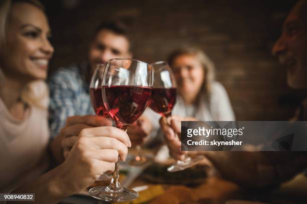 close up of a family toasting with red wine at home. - wine close up stock pictures, royalty-free photos & images