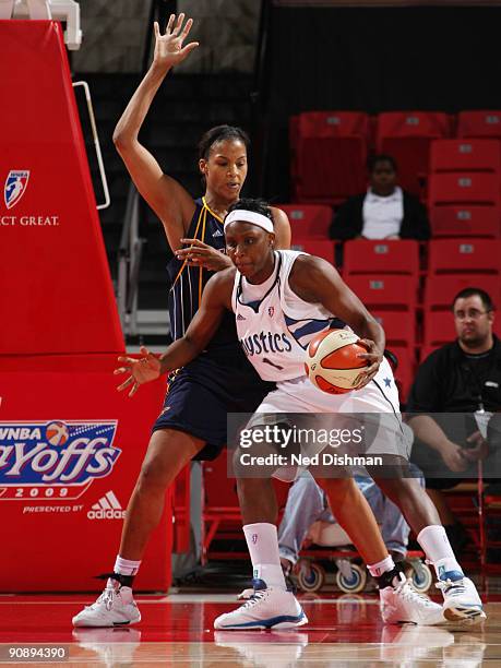 Crystal Langhorne of the Washington Mystics drives against Tammy Sutton-Brown of the Indiana Fever during Game One of the WNBA Eastern Conference...