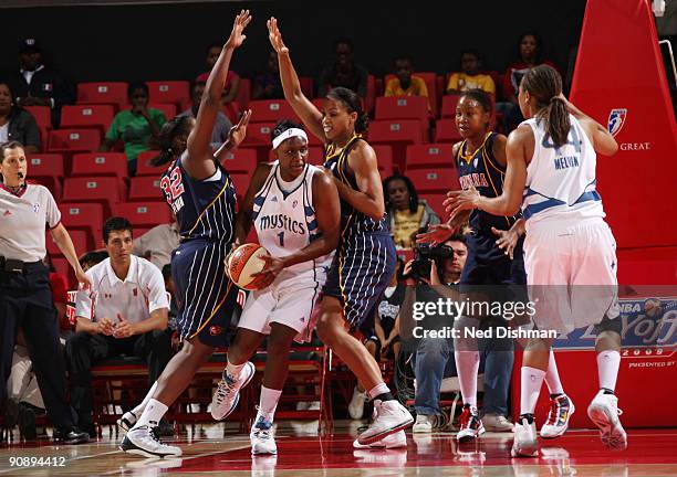 Crystal Langhorne of the Washington Mystics drives against Tammy Sutton-Brown of the Indiana Fever during Game One of the WNBA Eastern Conference...