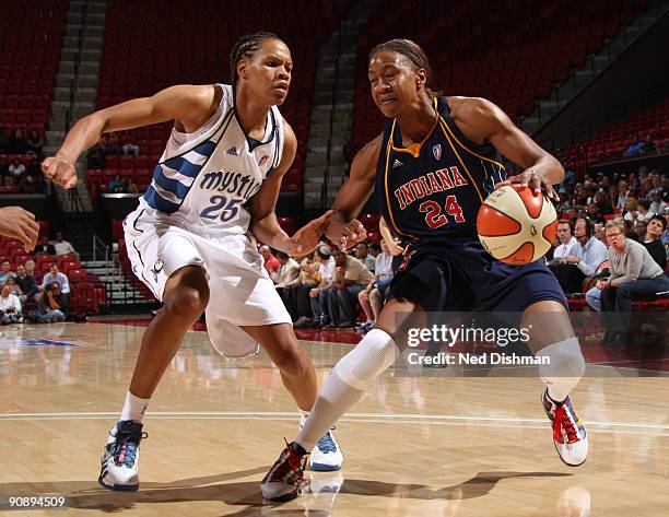 Tamika Catchings of the Indiana Fever drives against Monique Currie of the Washington Mystics during Game One of the WNBA Eastern Conference...