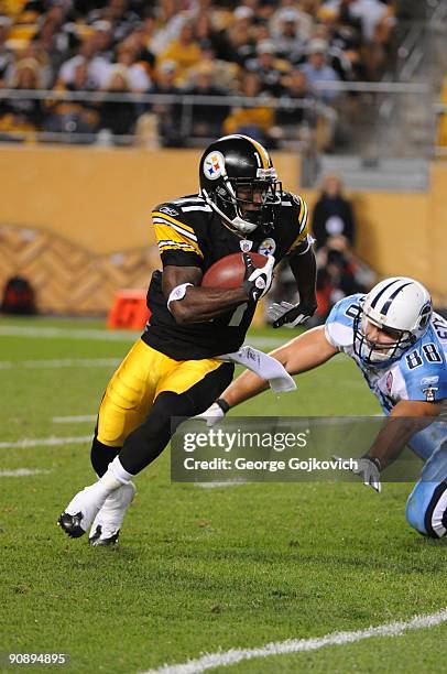 Kick returner Stefan Logan of the Pittsburgh Steelers runs with the football against Craig Stevens of the Tennessee Titans at Heinz Field on...