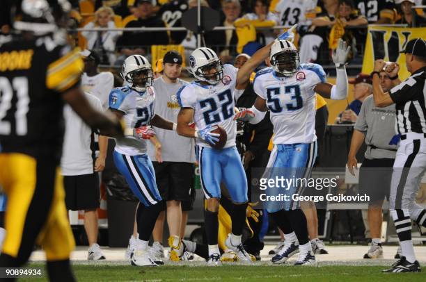 Safety Vincent Fuller of the Tennessee Titans and teammates Nick Harper and Keith Bulluck celebrate after Fuller intercepted a pass during a game...