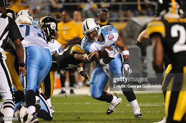 Running back LenDale White of the Tennessee Titans is hit by safety Troy Polamalu of the Pittsburgh Steelers at Heinz Field on September 10, 2009 in...