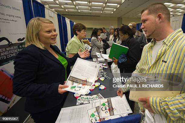 Transportation Security Administration recruiters Maggie Long and Linda Garwood talk with job seekers about part-time work during an employment guide...
