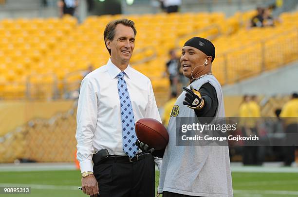 Sunday Night Football announcer Cris Collinsworth talks with wide receiver Hines Ward of the Pittsburgh Steelers before a game against the Tennessee...