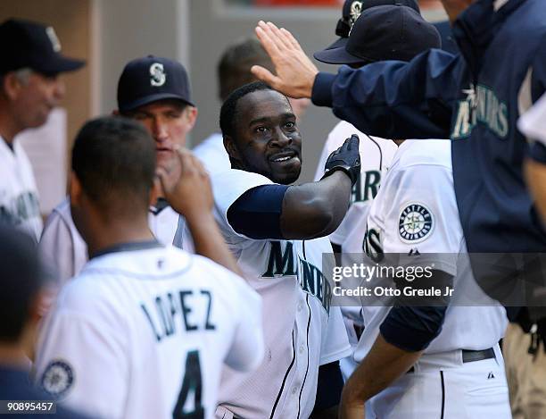 Bill Hall of the Seattle Mariners is congratulated by teammates after hitting a game tying homer in the ninth inning against the Chicago White Sox on...