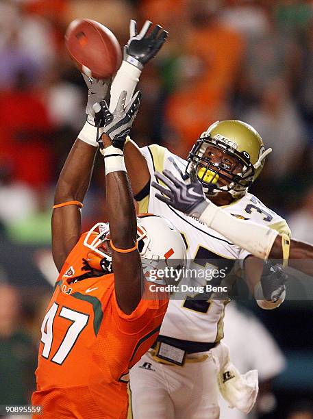 Cornerback Jerrard Tarrant Georgia Tech Yellow Jackets breaks up a pass intended for wide receiver LaRon Byrd of the Miami Hurricanes at Land Shark...
