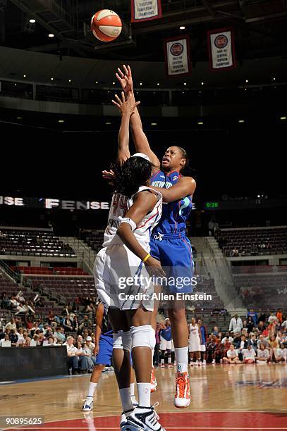 Kia Vaughn of the New York Liberty shoots over Taj McWilliams of the Detroit Shock during the WNBA game on September 10, 2009 at The Palace of Auburn...