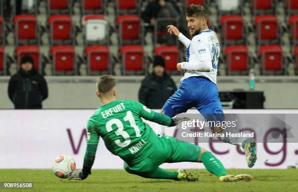 Goalkeeper Julian Knoll of Erfurt challenges Michel Niemeyer of Magdeburg during the 3.Liga match between FC Rot Weiss Erfurt and 1.FC Magdeburg at...