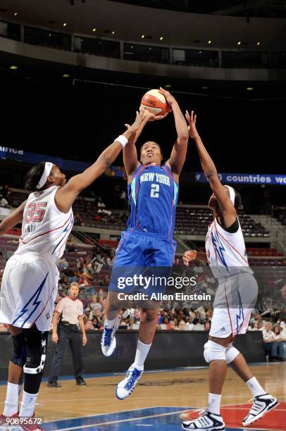 Erlana Larkins of the New York Liberty goes up for a shot over Cheryl Ford and Taj McWilliams of the Detroit Shock during the WNBA game on September...