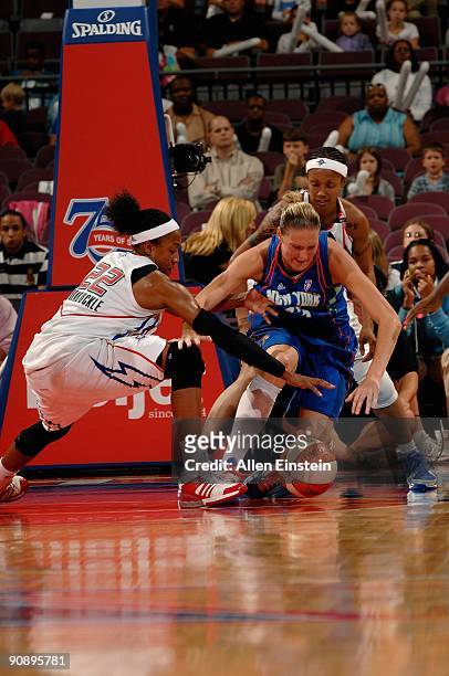 Catherine Kraayeveld of the New York Liberty goes after a loose ball against Alexis Hornbuckle and Deanna Nolan of the Detroit Shock during the WNBA...