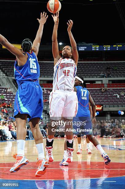 Crystal Kelly of the Detroit Shock puts a shot up over Kia Vaughn and Essence Carson of the New York Liberty during the WNBA game on September 10,...