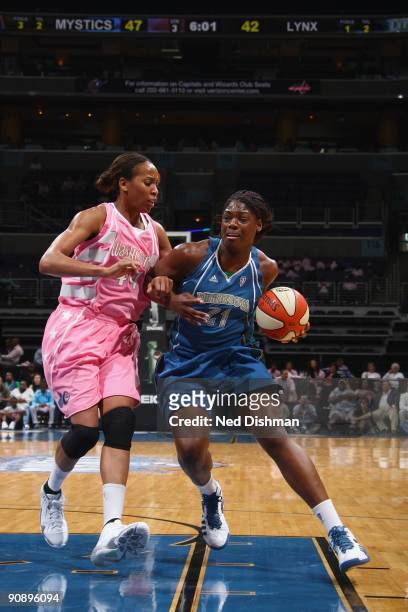 Nicky Anosike of the Minnesota Lynx drives against Chasity Melvin of the Washington Mystics during the game at the Verizon Center on August 30, 2009...