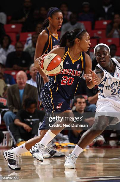 Briann January of the Indiana Fever drives against Matee Ajavon of the Washington Mystics during Game One of the WNBA Eastern Conference Semifinals...