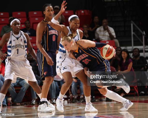Katie Douglas of the Indiana Fever drives against Alana Beard of the Washington Mystics during Game One of the WNBA Eastern Conference Semifinals at...