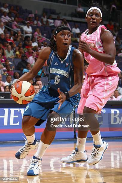 Roneeka Hodges of the Minnesota Lynx drives against Crystal Langhorne of the Washington Mystics during the game at the Verizon Center on August 30,...