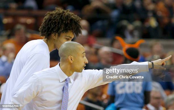 Head coach Shaka Smart of the Texas Longhorns talks with Jericho Sims of the Texas Longhorns during the game with the Iowa State Cyclones at the...