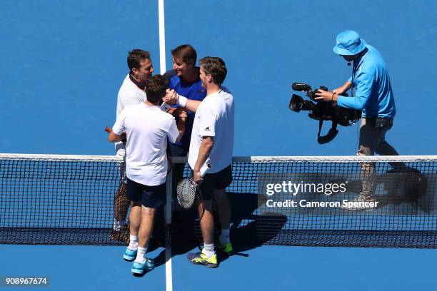 Todd Woodbridge of Australia and Thomas Enqvist of Sweden interact with Jacco Eltingh of the Netherlands and Paul Haarhuis of the Netherlands in...