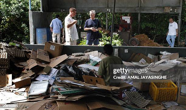 In this photograph taken on September 8, 2009 hotel guests are shown the recycling facility at the luxury Soneva Fushi island resort in the Maldives....