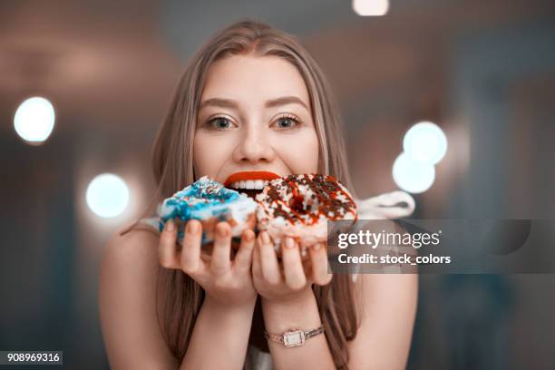 eating delicious donuts - biting donut stock pictures, royalty-free photos & images