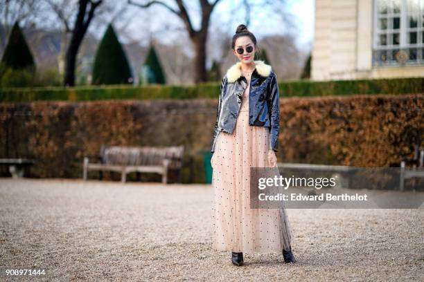 Chriselle Lim wears a black jacke, a lace dress , after Dior, during Haute Couture Spring/Summer 2018, on January 22, 2018 in Paris, France.