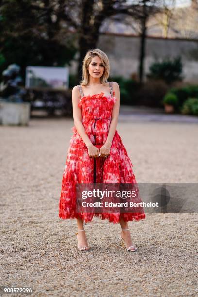 Maha Al Shamsi wears a red dress, after Dior, during Haute Couture Spring/Summer 2018, on January 22, 2018 in Paris, France.