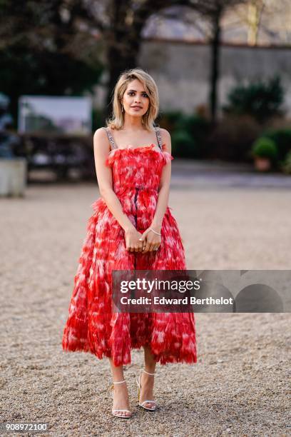 Maha Al Shamsi wears a red dress, after Dior, during Haute Couture Spring/Summer 2018, on January 22, 2018 in Paris, France.