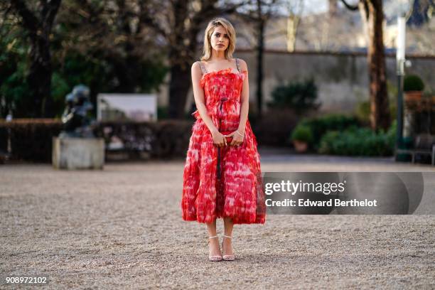 Maha Al Shamsi wears a red dress, after Dior, during Haute Couture Spring/Summer 2018, on January 22, 2018 in Paris, France.