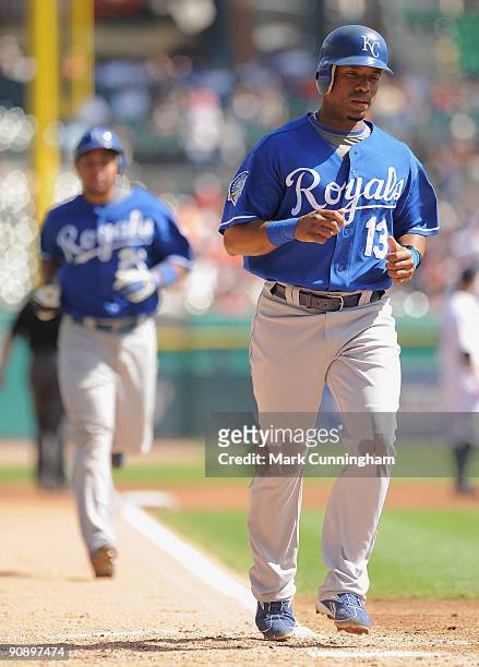 Alberto Callaspo of the Kansas City Royals scores ahead of Miguel Olivo on Olivo's three-run home run in the 3rd inning against the Detroit Tigers...