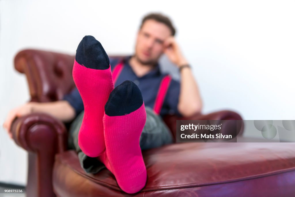 Man Sitting in an Armchair and Focus on his Feet