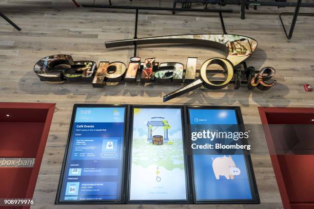 Capital One Financial Corp. Signage hangs above monitors at the company's Cafe in the Lincoln Park neighborhood of Chicago, Illinois, U.S., on...