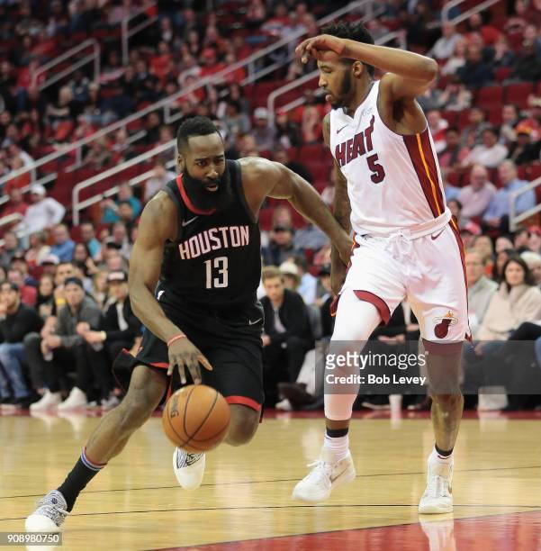 James Harden of the Houston Rockets drives around Derrick Jones Jr. #5 of the Miami Heat at Toyota Center on January 22, 2018 in Houston, Texas. NOTE...