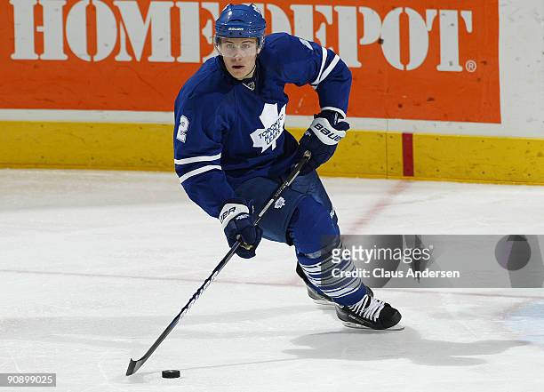 Luke Schenn of the Toronto Maple Leafs skates with the puck in a pre-season game against the Philadelphia Flyers on September 17, 2009 at the John...