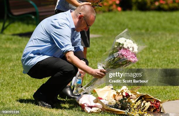 People lay flowers at a plaque to remember those affected by the Bourke Street Mall tragedy at Parliament Gardens Reserve after attending a memorial...