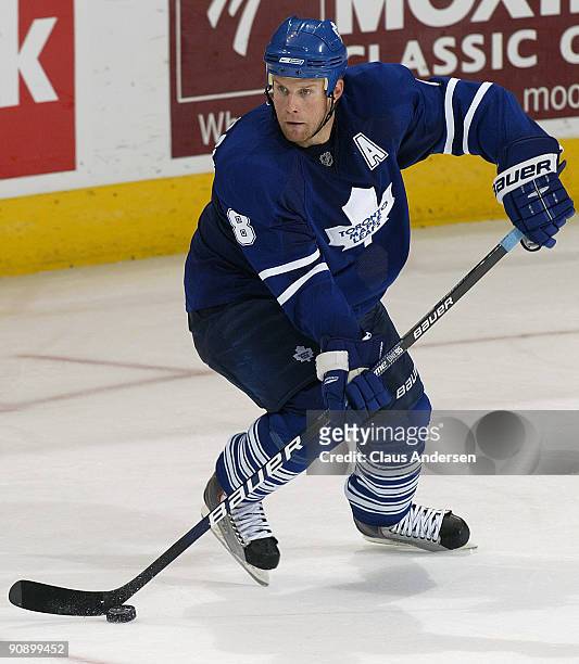 Mike Komisarek of the Toronto Maple Leafs skates with the puck in a preseason game against the Philadelphia Flyers on September 17, 2009 at the John...