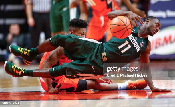 Lourawls Nairn Jr. #11 of the Michigan State Spartans tumbles after the ball against Te'Jon Lucas of the Illinois Fighting Illini at State Farm...
