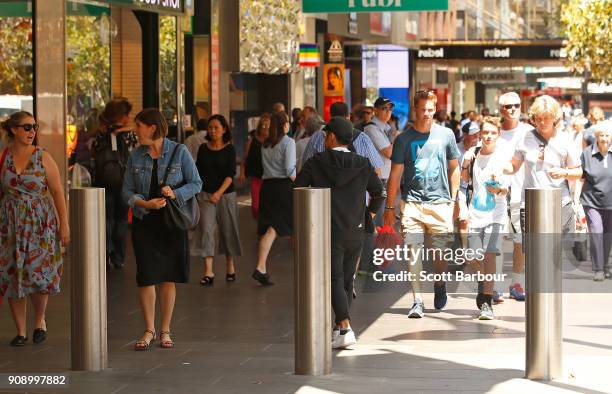 People walk past bollards on Bourke Street Mall as a memorial is held for victims of the Bourke Street Mall Attack on January 23, 2018 in Melbourne,...