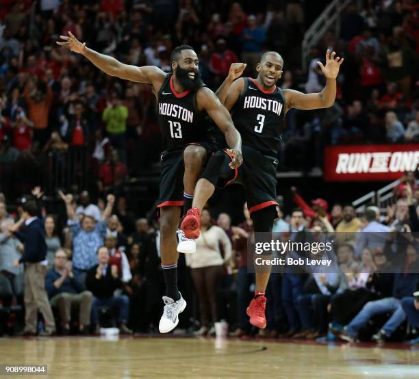 James Harden and Chris Paul of the Houston Rockets celebrate after Paul made a three-point shot late in the fourth quarter Miami Heat at Toyota...